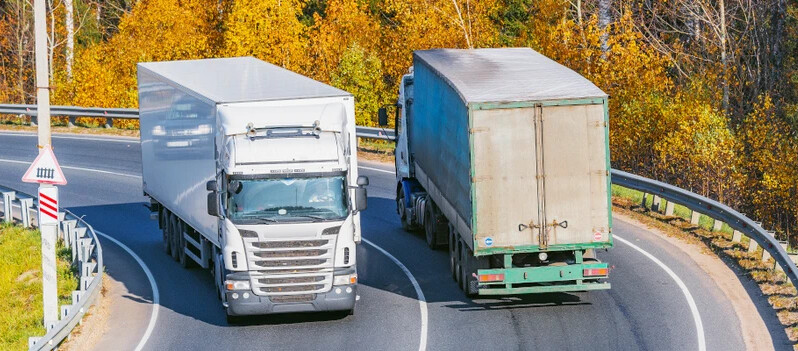 two trucks driving along