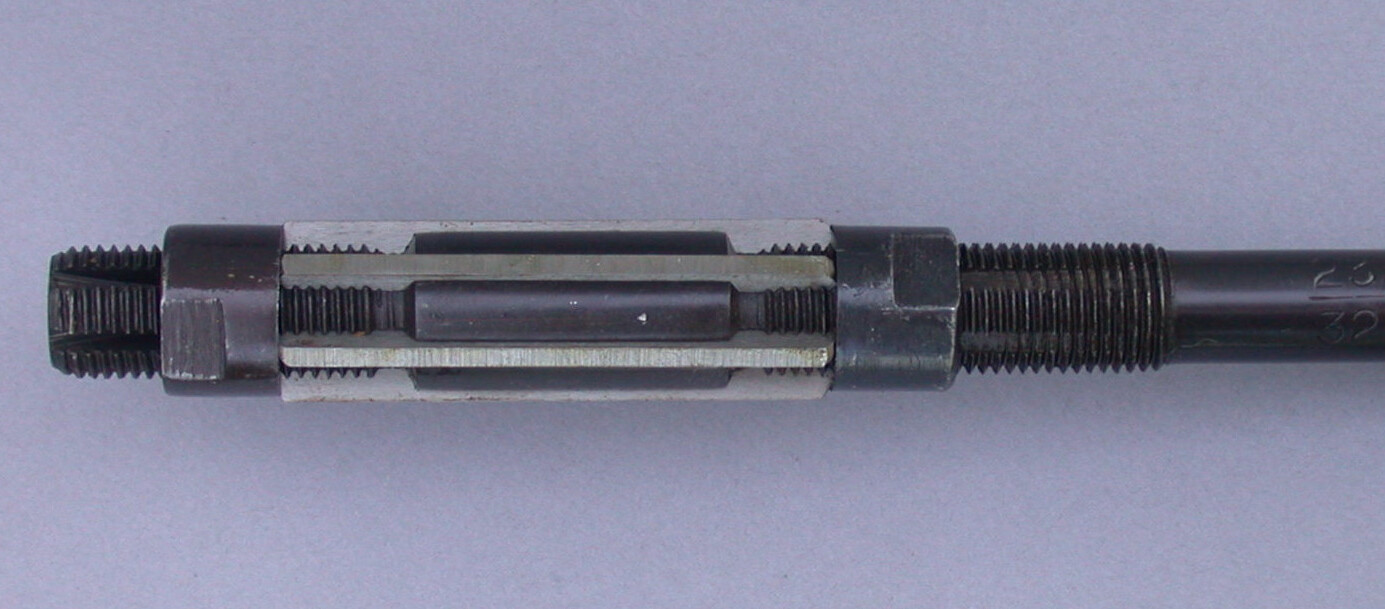 Adjustable hand reamer with replaceable blades and threaded adjustment collars 